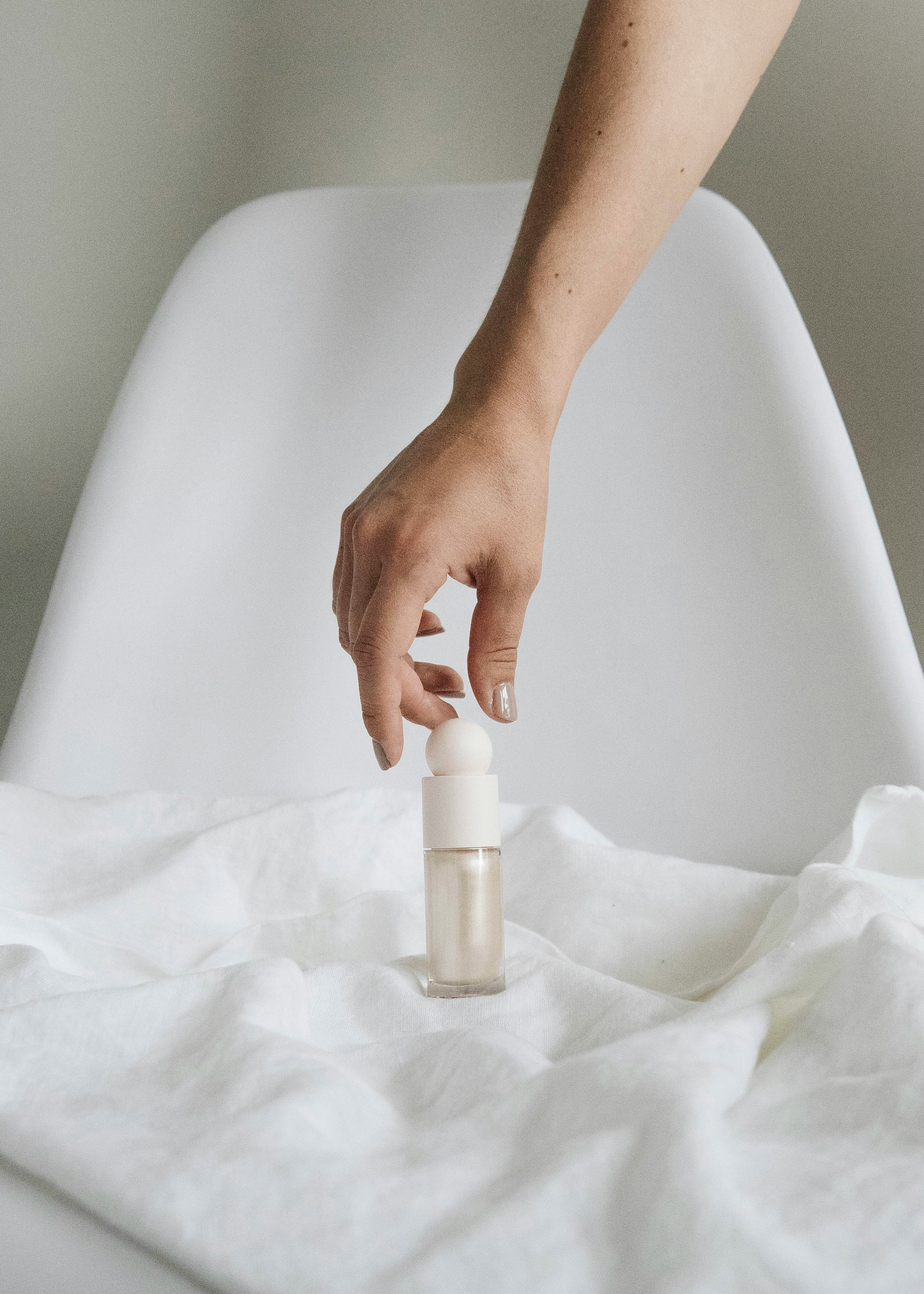 person holding white plastic bottle